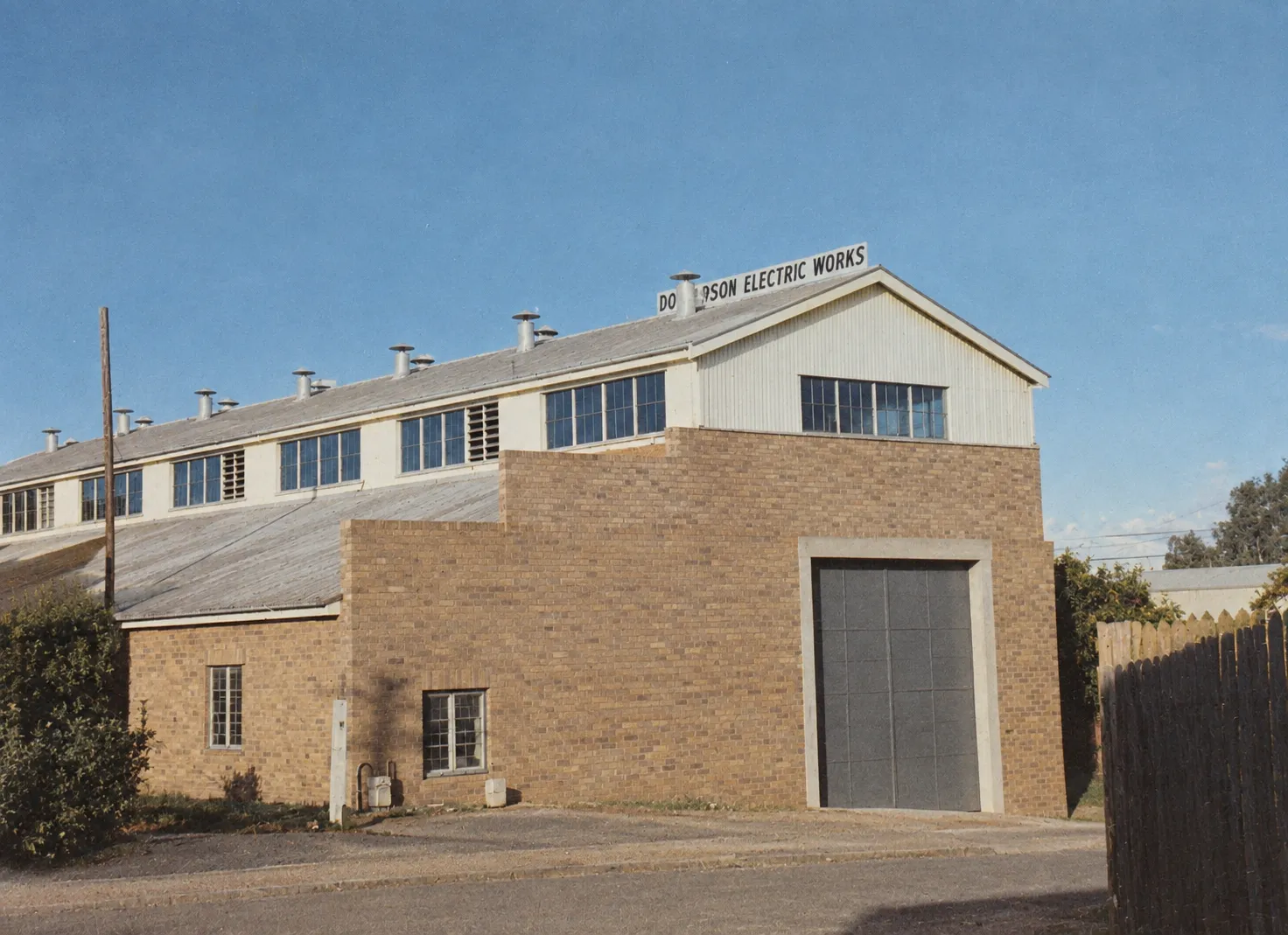 Donaldson Electric Works brick workshop with roller door and roof sign, Toowoomba